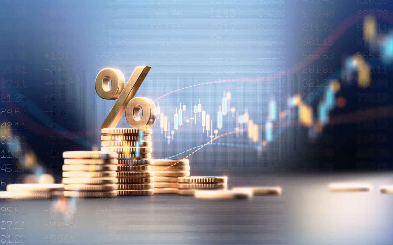 Percentage sign on top of coin stacks before a financial graph